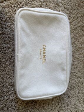 NWOT CHANEL White Cosmetic Pouch with gold zip.